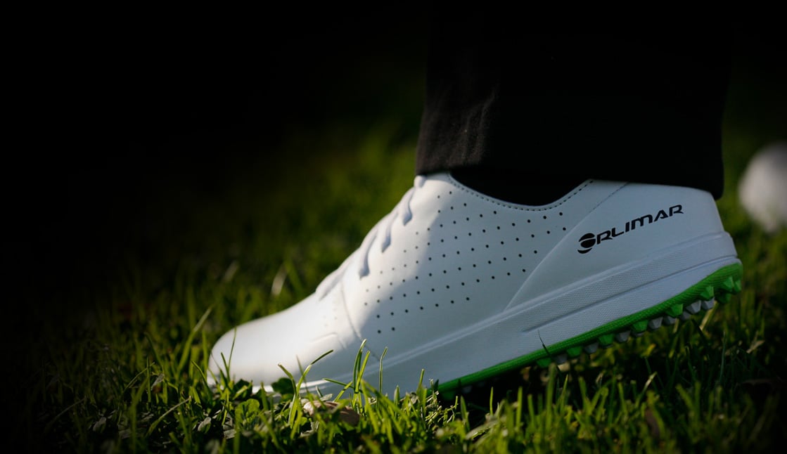 person close-up of an Orlimar men's spikeless left golf shoe