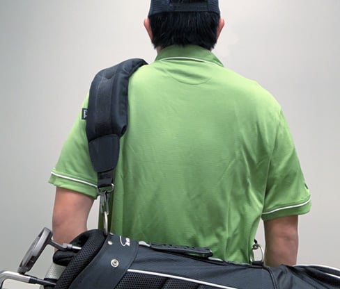 person with a Intech Single Padded Adjustable Strap on a golf bag hung over their shoulder