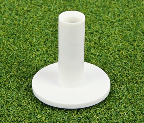 rubber golf tee sitting on the surface of the Orlimar 3' x 5' Residential Golf Mat