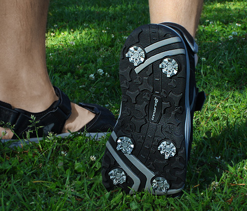 person wearing the Orlimar Men's Golf Sandals featuring spikes for superb traction
