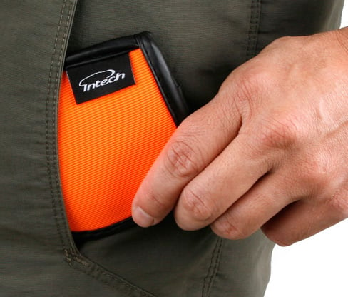 a person putting a Intech Squeaky Clean Pocket Golf Ball Washers into their pants pocket