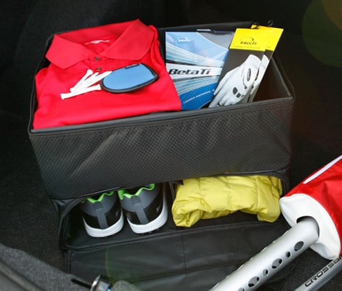 opened Intech Golf Double Row Trunk Organizer with golf shoes, golf balls, gloves and other accessories inside trunk of a car