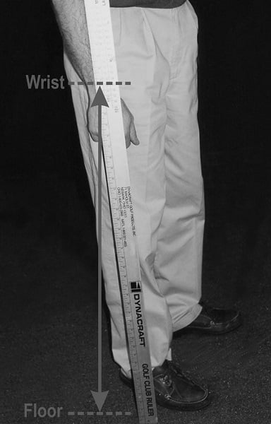 measuring wrist to floor measurement on a golfer