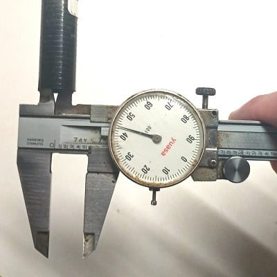 measuring the inside diameter of a graphite shaft with calipers